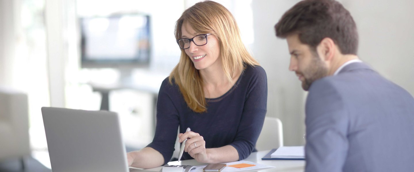 Woman and man discuss results in the office at avitea