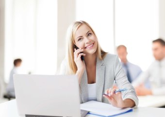Blonde woman on the phone in the coworking space 