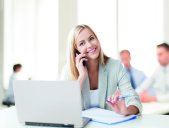 Blonde woman in office on the phone