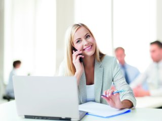 Blonde woman in office on the phone